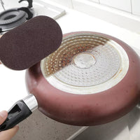 Magic Sponge with ergonomic handle for tough stain, grease, and grime removal, ideal for cleaning countertops, sinks, and tiles with ease and comfort.